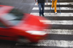 Car crossing dangerously fast over crosswalk in front of pedestrians before a Pedestrian Accident Lawyer Watkinsville GA is called for help