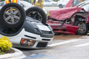 One car with front end smashed in and the other flipped over before needing an Uber Accident Lawyer Watkinsville GA