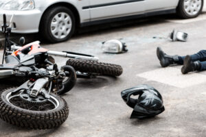 Motorcycle accident where person is lying on the ground before their family calls a Wrongful Death Lawyer Winder GA