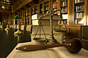 business litigation attorney with a gavel and scales in front of shelves of books